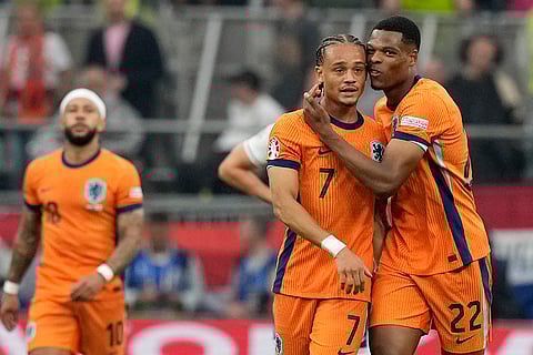 Xavi Simons celebrates with Denzel Dumfries after scoring a goal